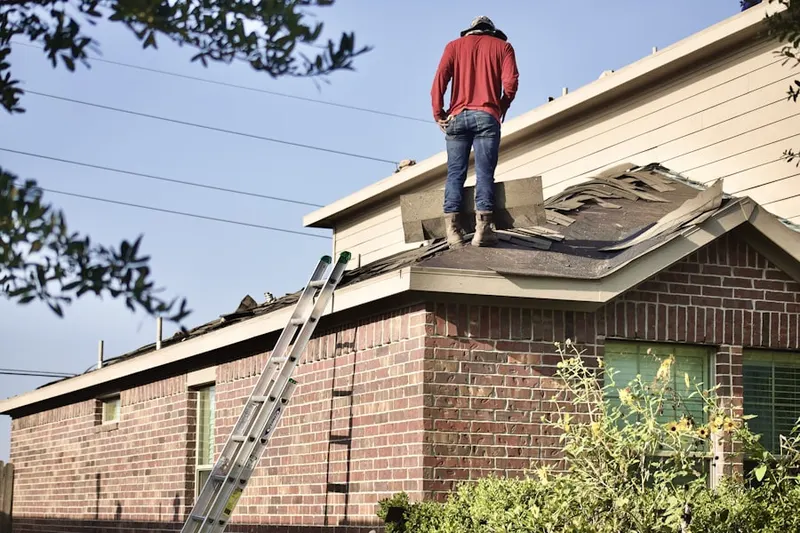Professional roofer working on a residential roof in Smalleytown